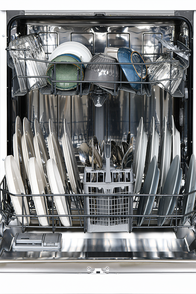 Open dishwasher with clean dishes inside on a white background