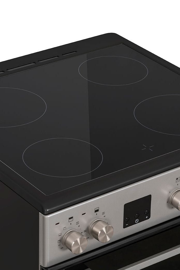 Stainless steel electric cooktop with black glass surface on a white background