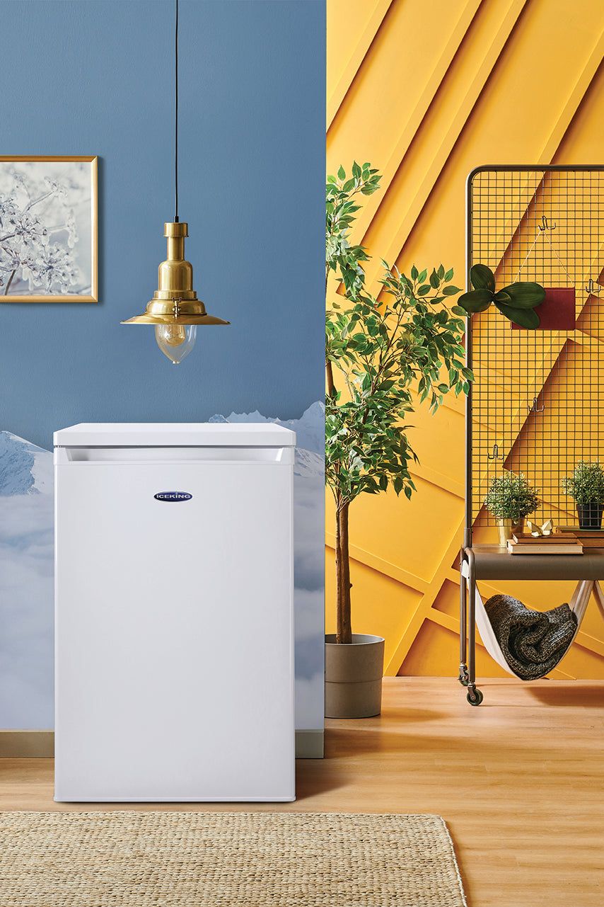 White refrigerator in a room with blue and yellow walls, shelves, and plants.